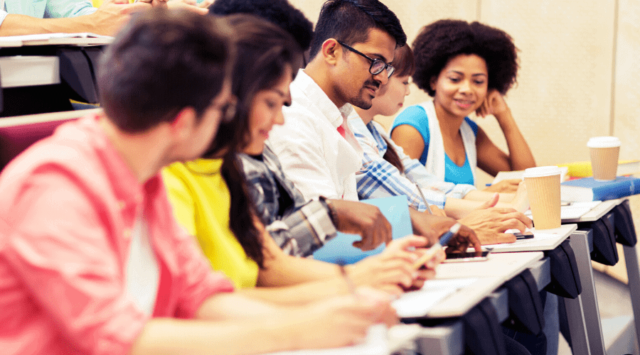 Concept photo of a small group of young people filling out forms.