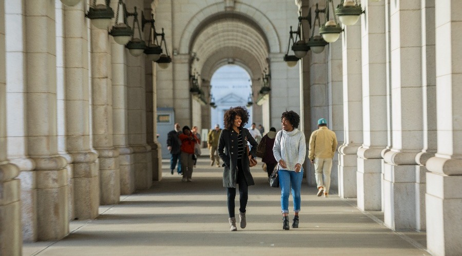 Concept photo of students walking around a college campus.