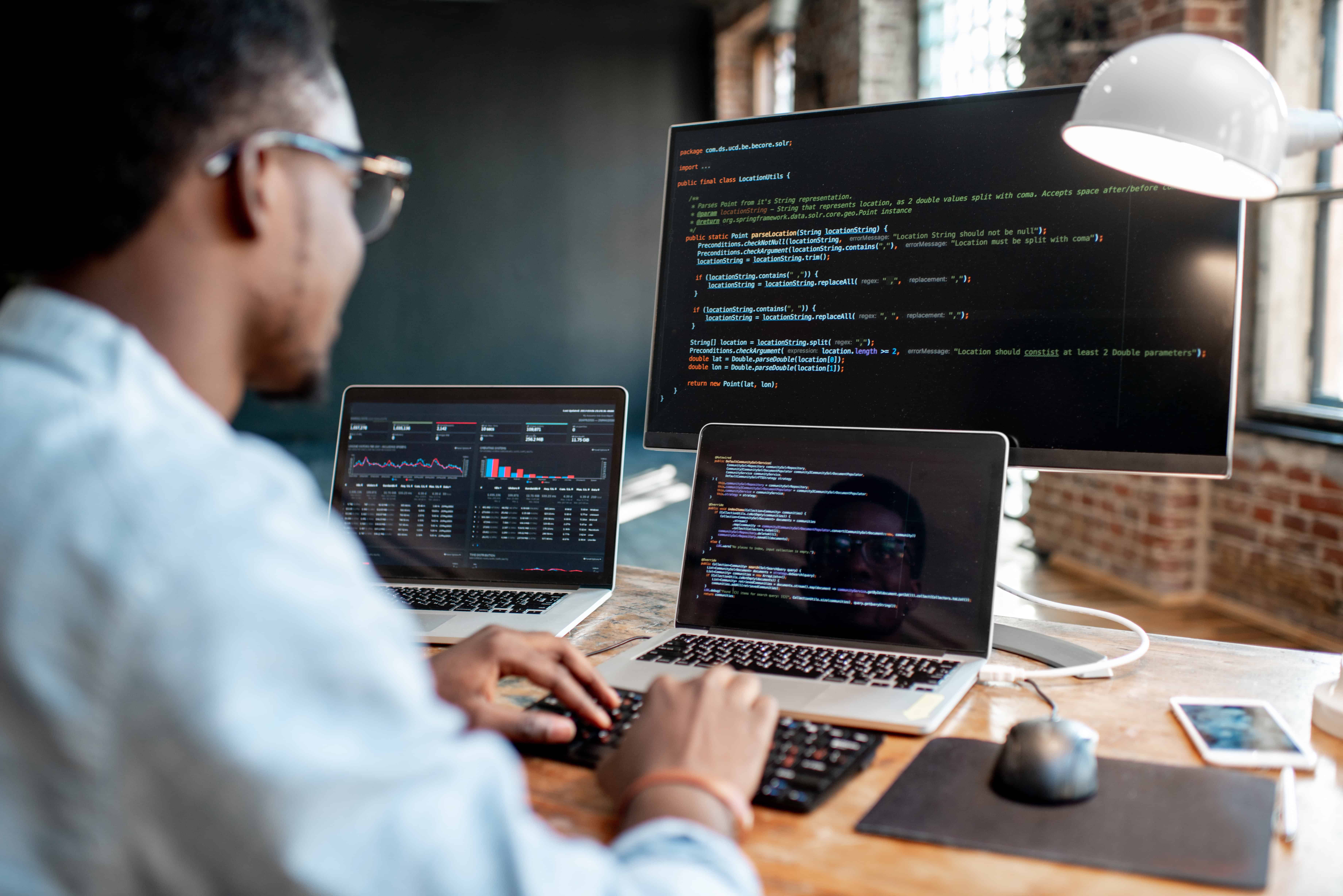 Concept photo of a man staring at computer screens.