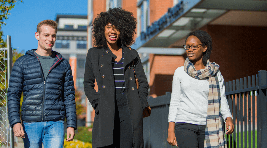 Photo of 3 students talking.