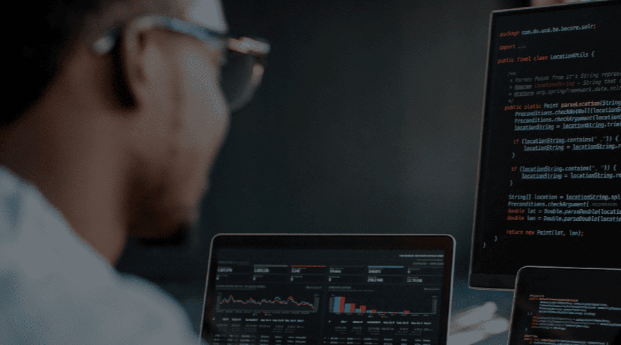 Man sitting at computer monitors