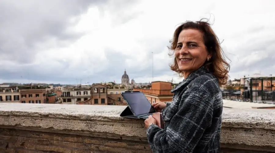 Diplomatic Technology Officer in Rome on a rooftop overlooking city.